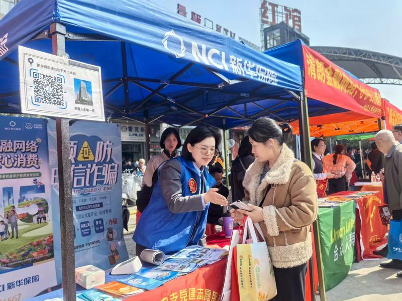 新华保险广西分公司员工向客户做金融知识宣传 新华保险广西分公司供图