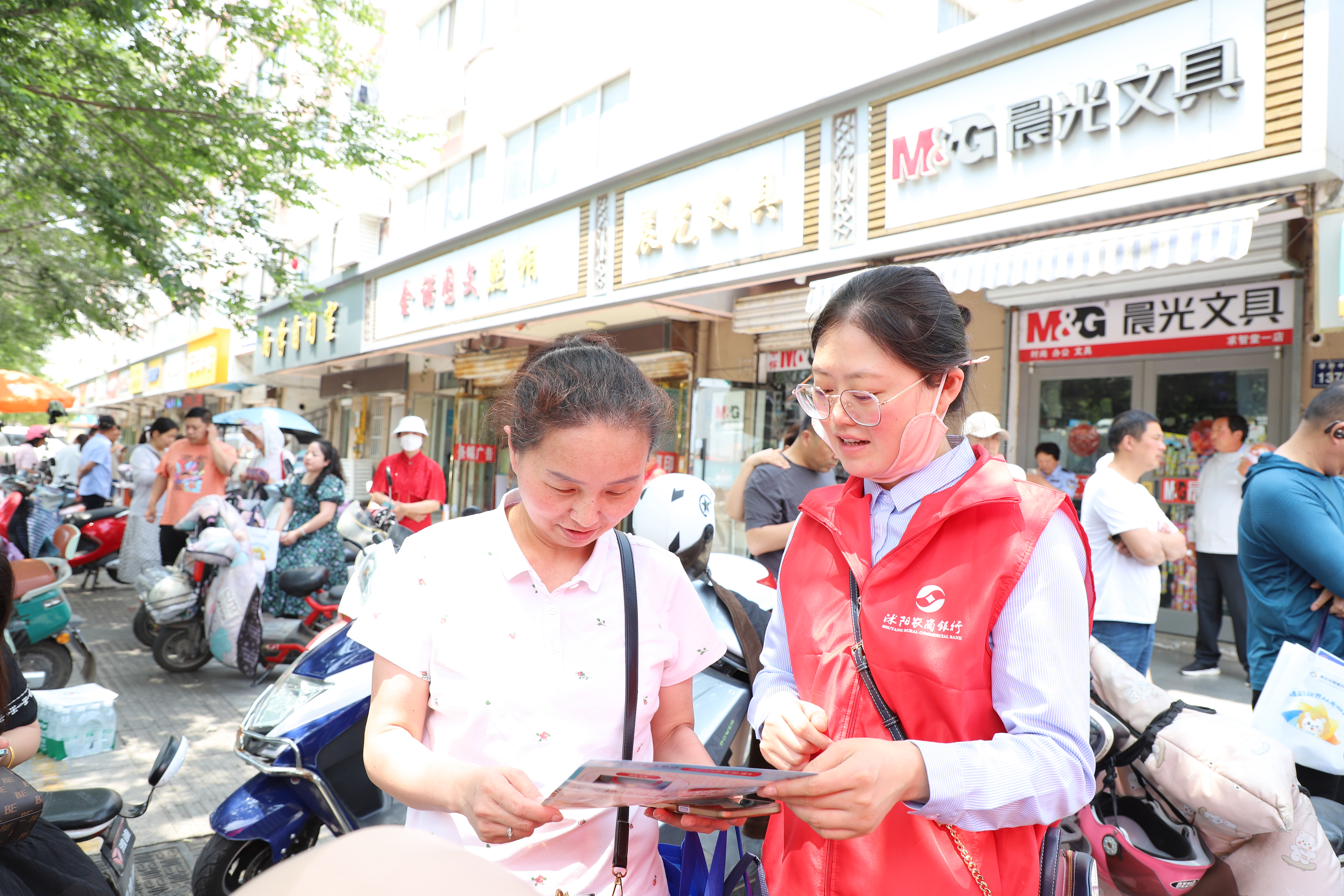 沭阳农商银行客户经理在步行街商圈为商户讲解金融知识(胡玲玲 摄)